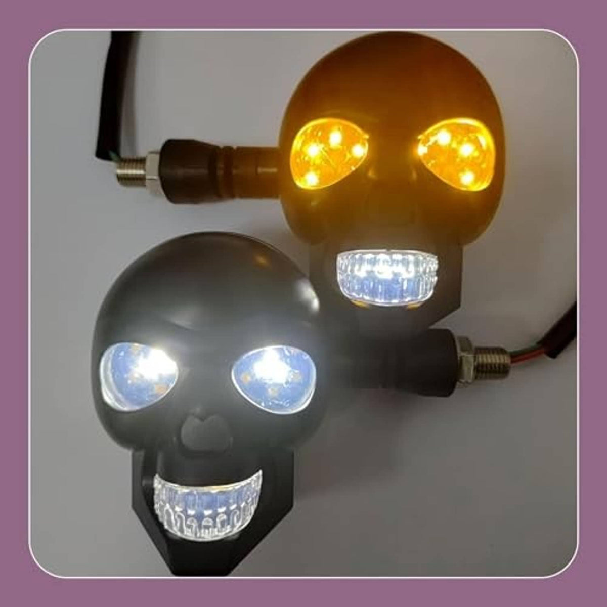 Pair of skull-shaped LED turn signal lights with amber top lights and white LEDs