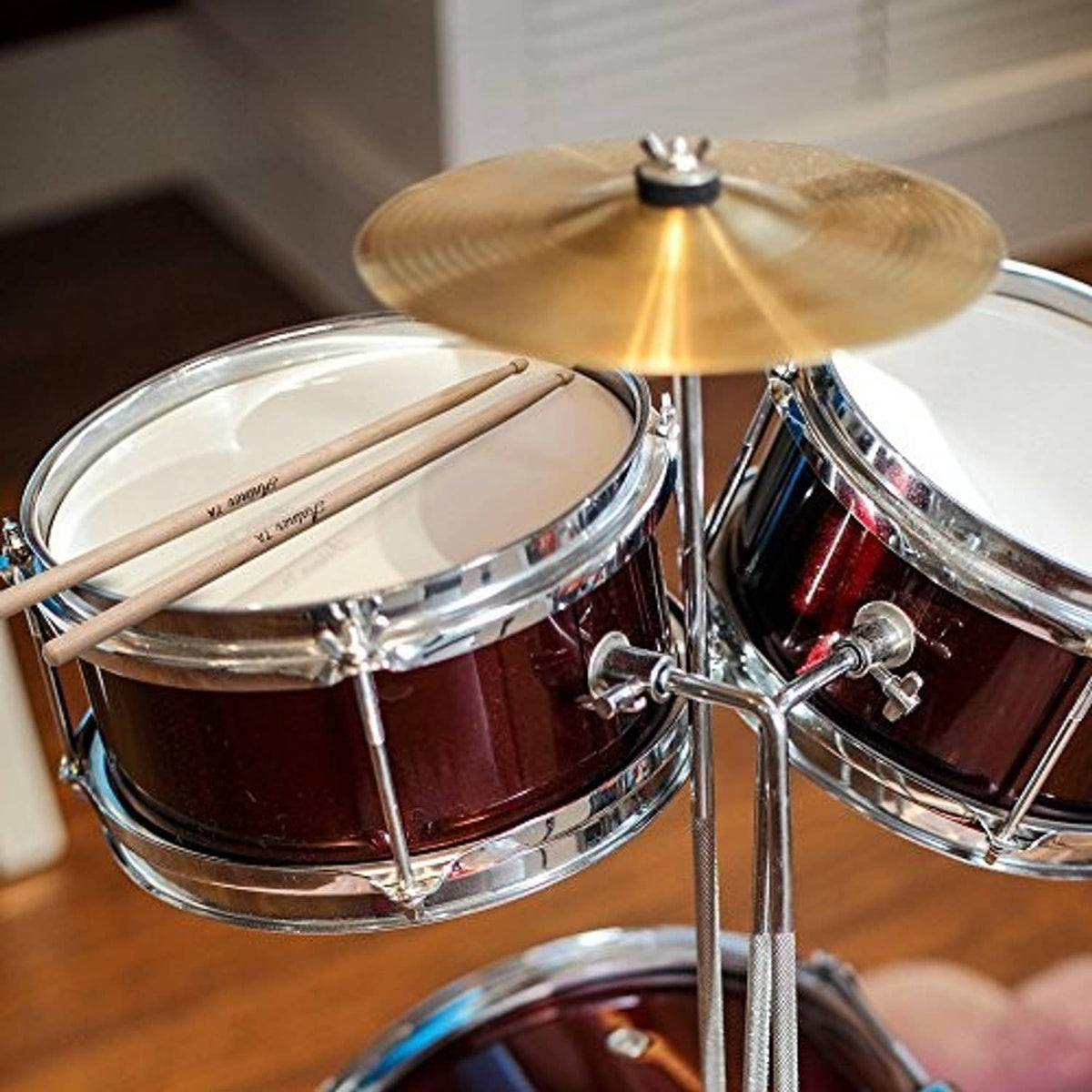 Maple wood drumsticks resting on a snare drum