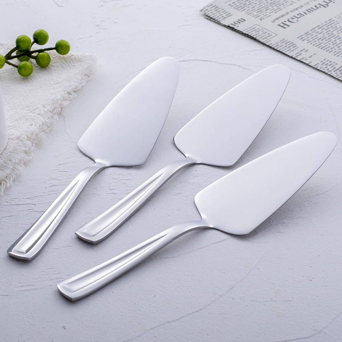 Stainless steel pie cake server trio with white triangular blades and long polished handles