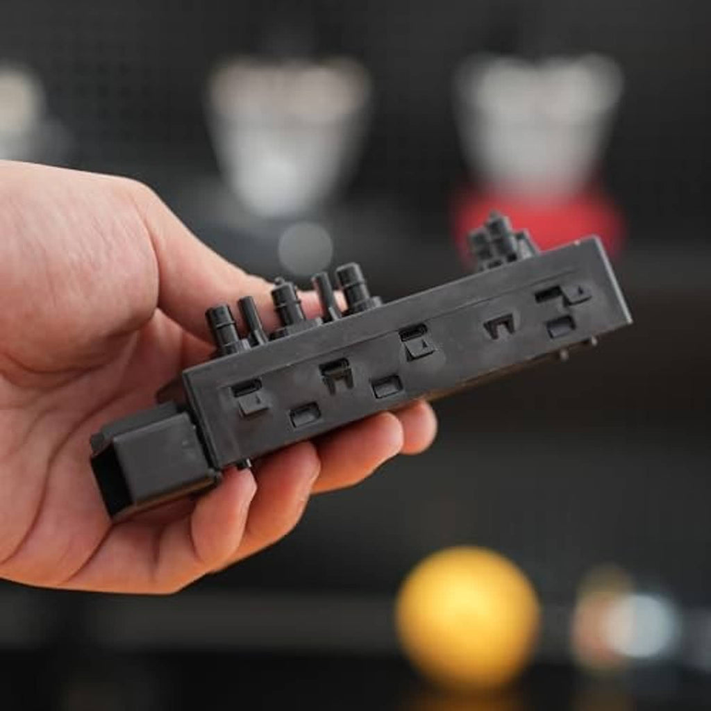 Power seat switch module back side with wiring ports and plastic mounting tabs