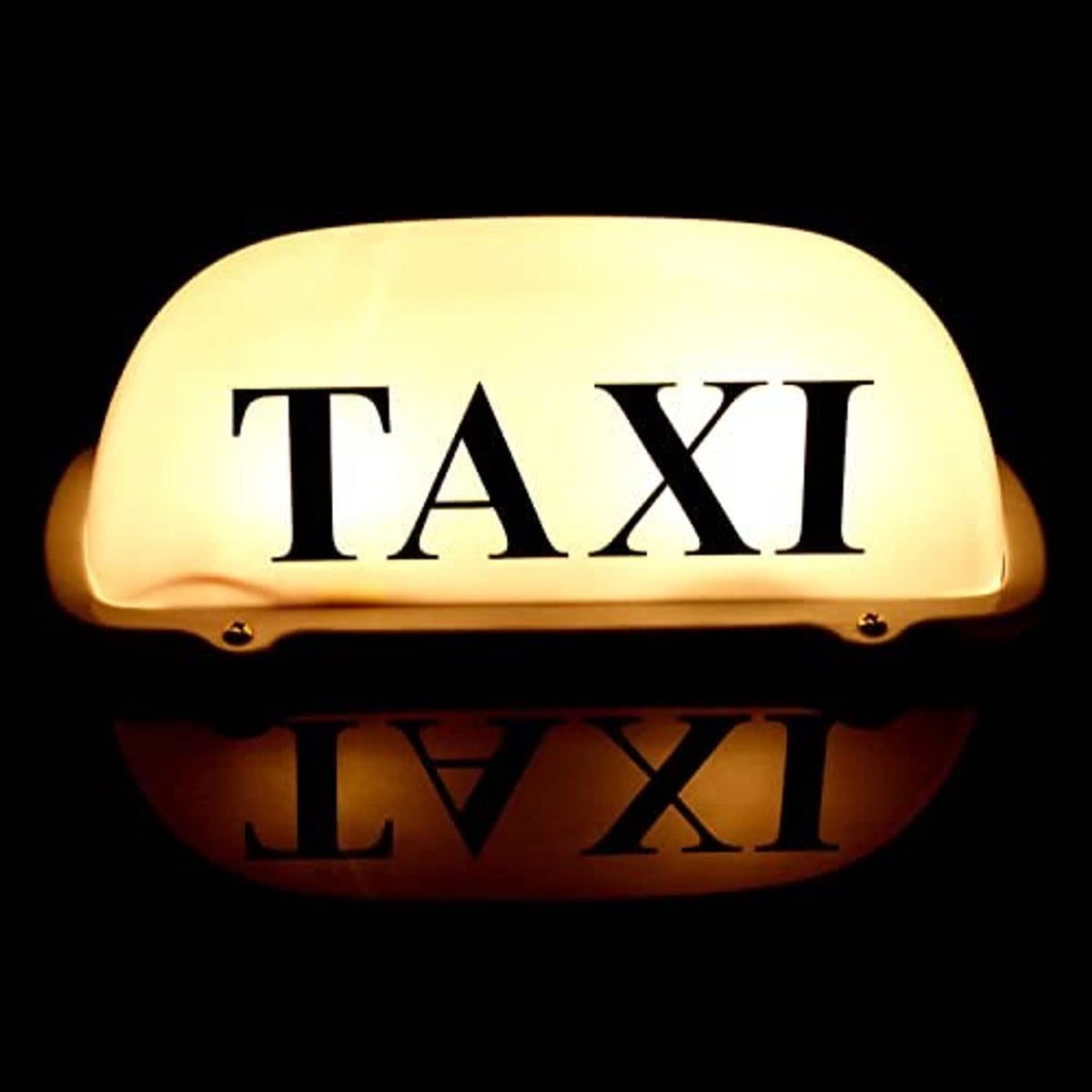 Glowing yellow taxi roof LED sign with “TAXI” lettering and lit lens face.