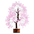 Rose quartz crystal tree with pink crystal leaves and dark trunk on wood base