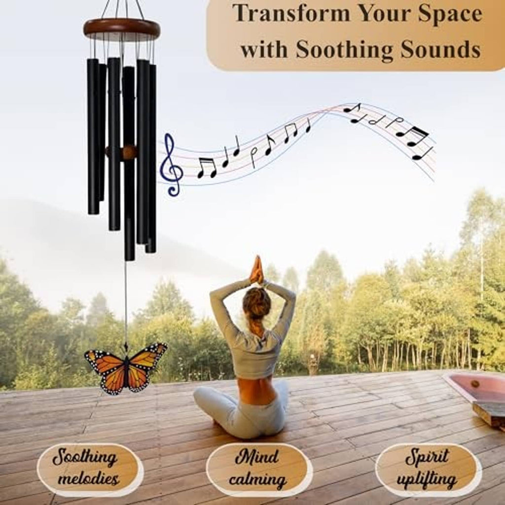 Monarch butterfly wind chime with black tubes and hanging glass butterfly pendant outdoors