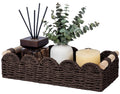 Brown woven toilet paper storage basket with rounded edge and beige rope handles