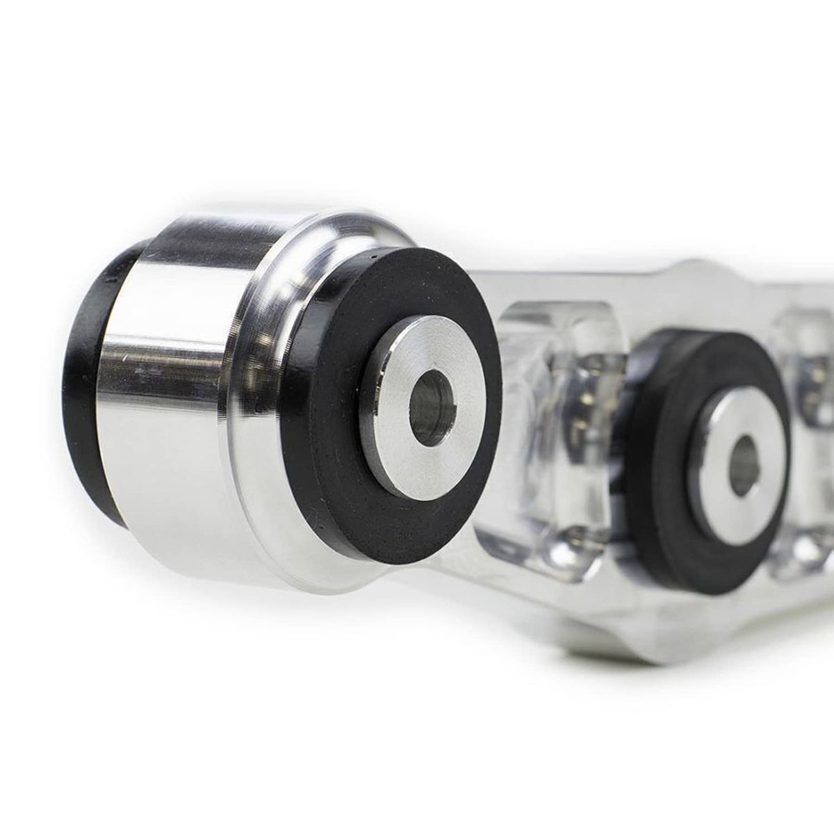 Close-up of silver control arm bushing end with black rubber insert