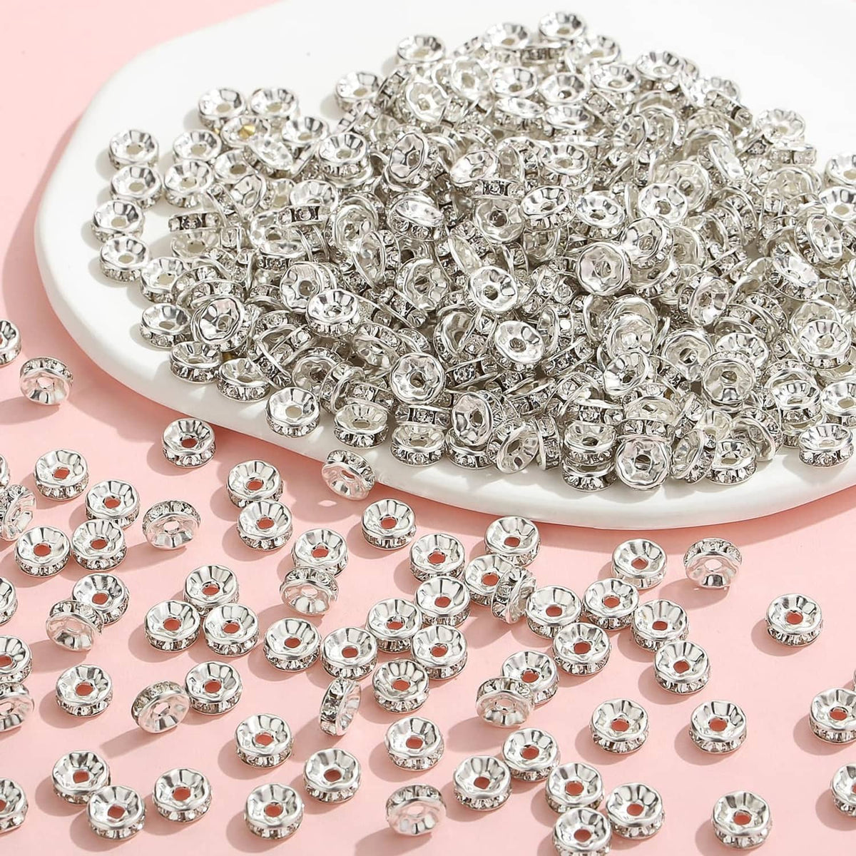 Pile of silver rhinestone rondelle spacer beads with faceted crystal centers
