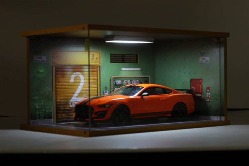 1:18 model car garage display case with orange car inside behind clear acrylic