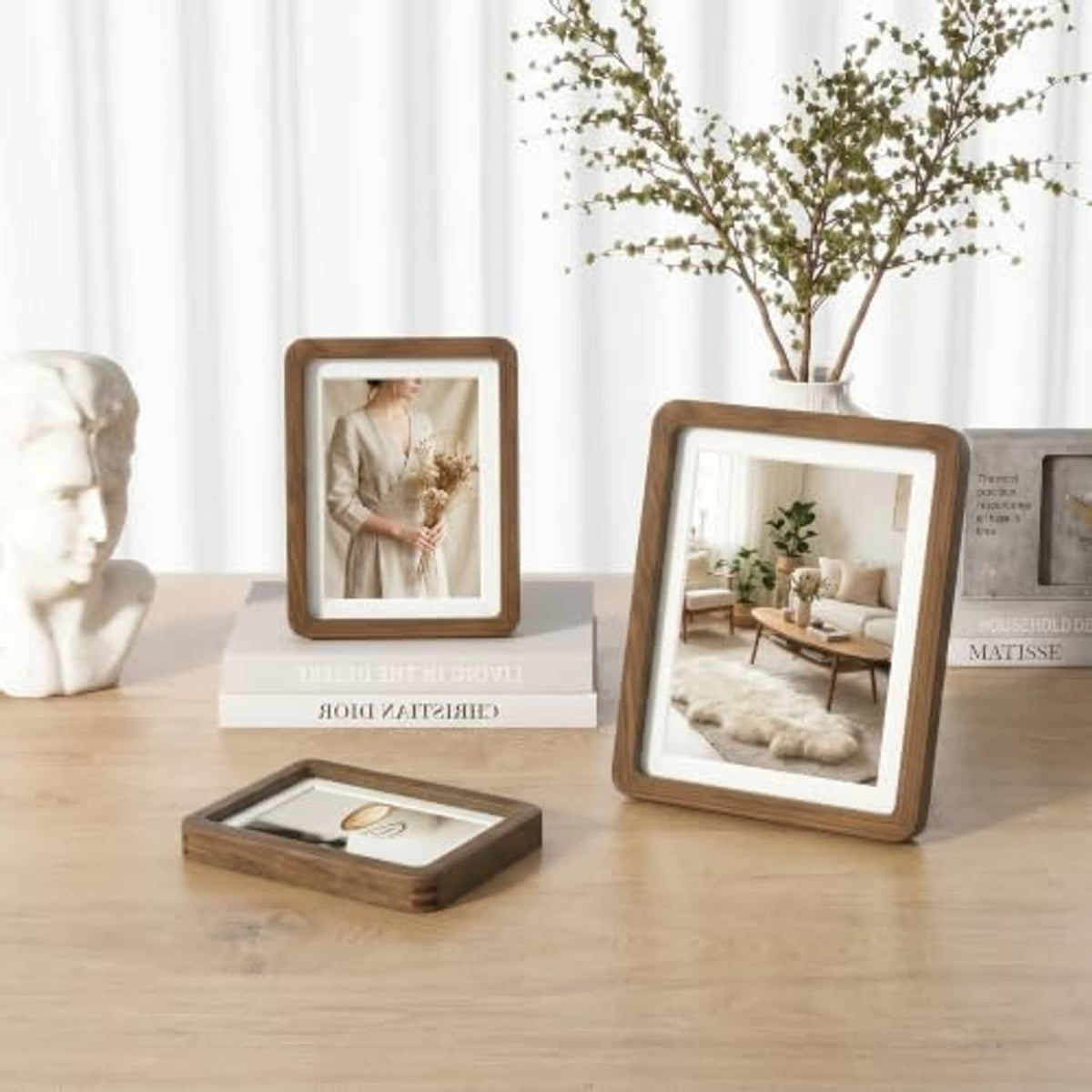 Walnut picture frames on display with glass fronts and beige photo mats