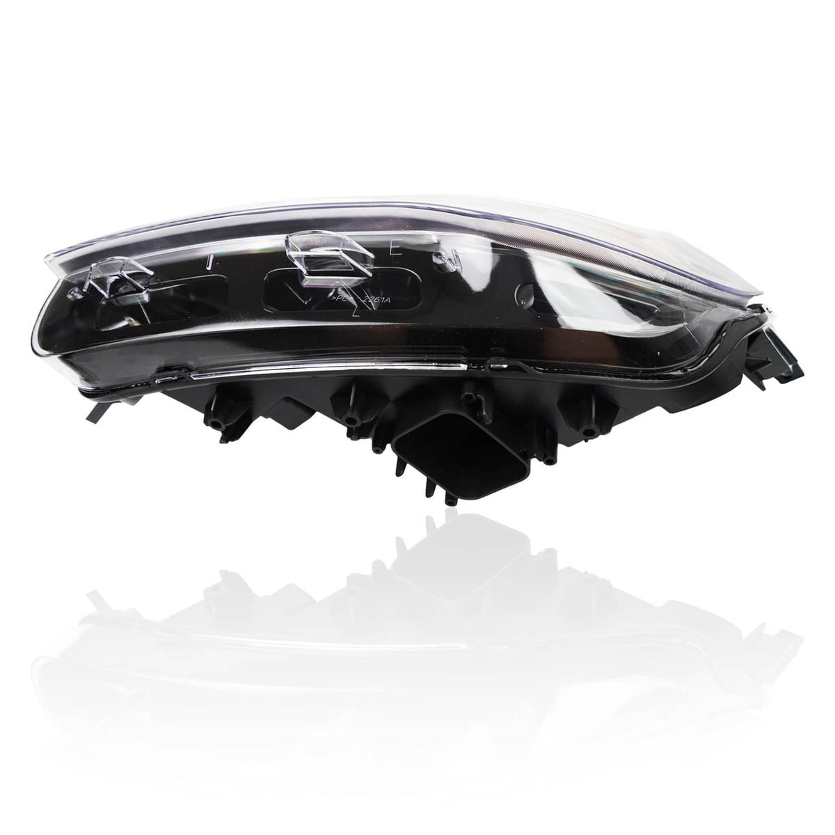Black headlight housing with clear outer lens and internal reflector components, side view