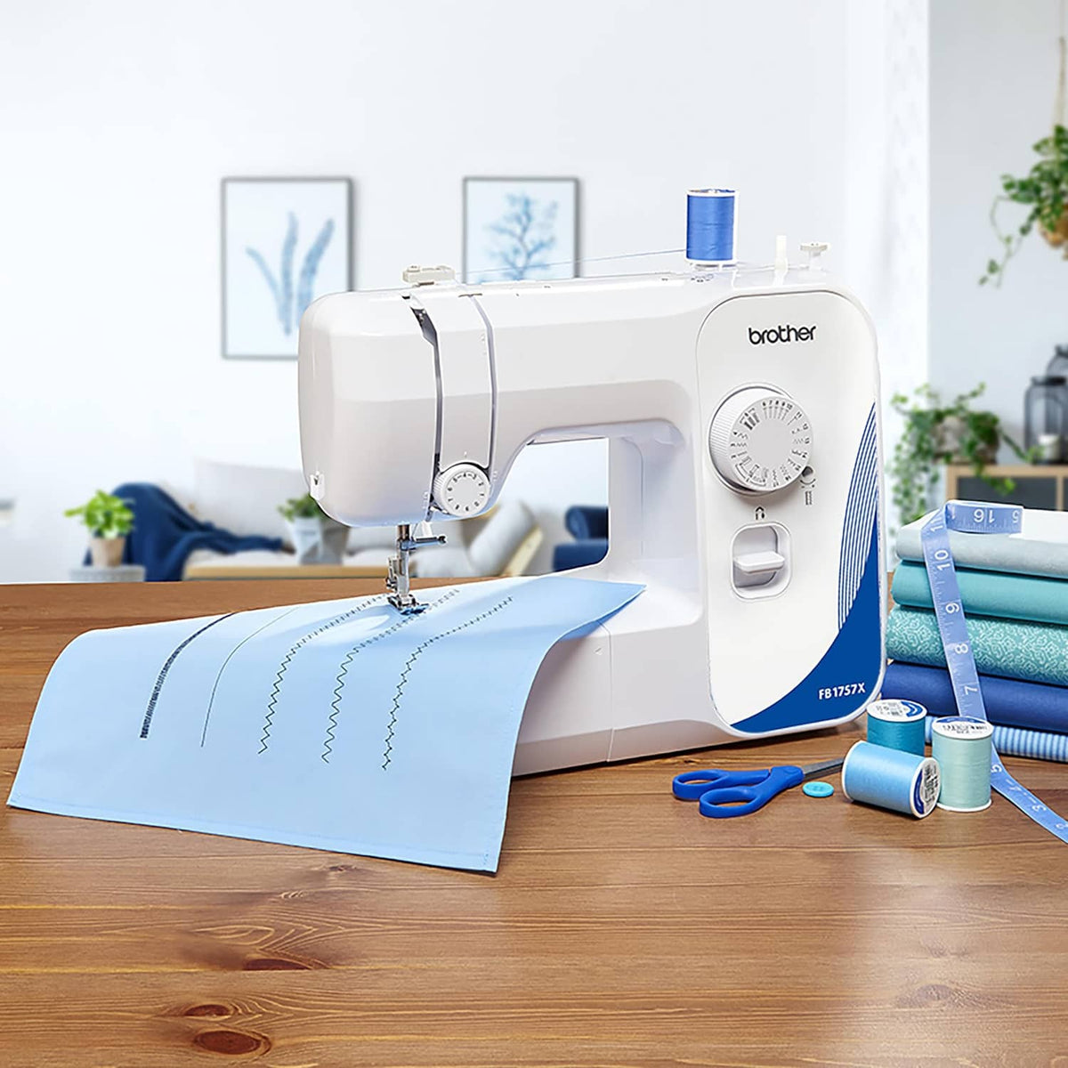 White Brother mechanical sewing machine with blue accents and thread tools on table