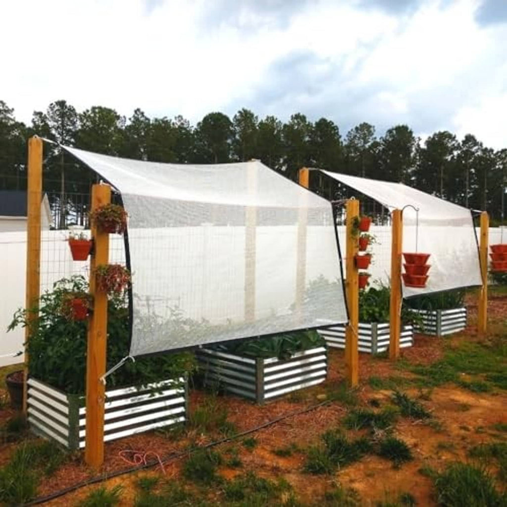 Silver reflective shade cloth canopy panels on wooden privacy-frame sides