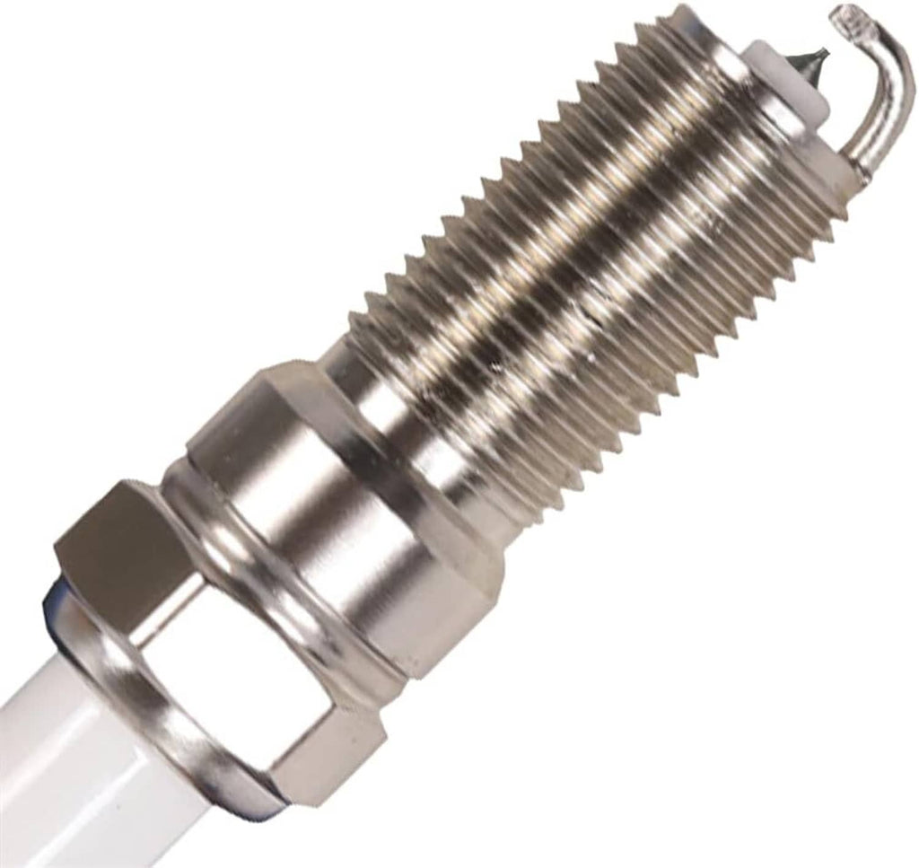 Spark plug close-up with threaded metal shell and electrode tip