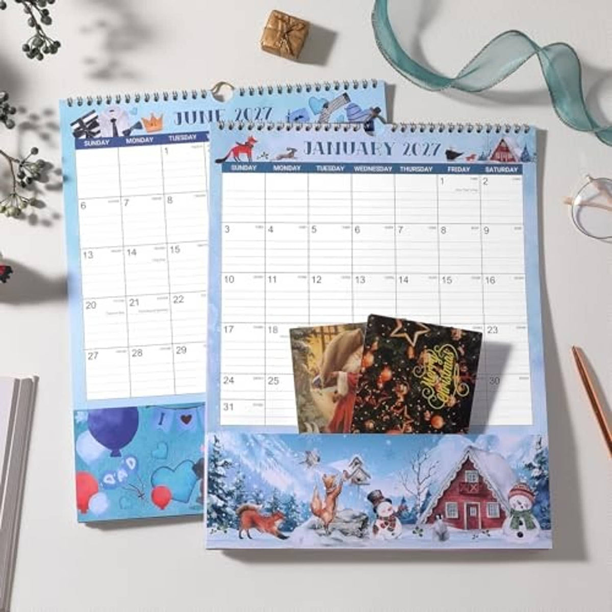Pocket calendars featuring June 2027 and January 2027 pages with seasonal artwork