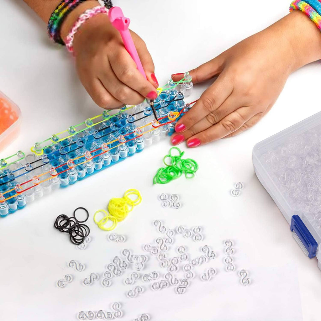 Loom rubber band bracelet setup with small bands, hands arranging on a frame