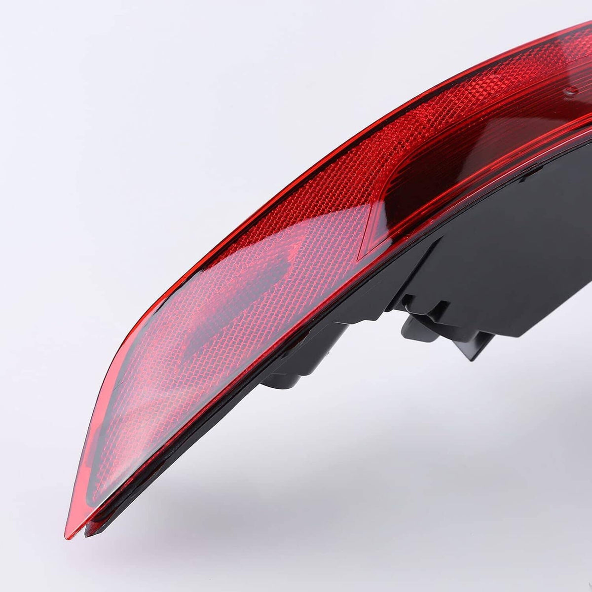 Red outer tail light lens with black mounting frame, curved edge view