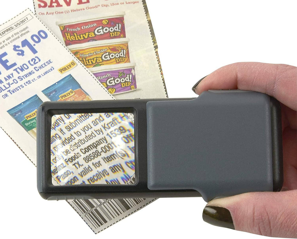 Gray LED magnifier focusing on coupon print through the illuminated lens