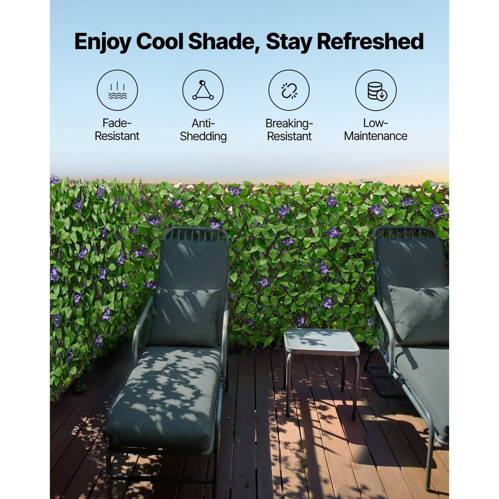 Artificial ivy privacy screen behind outdoor chairs, green leaves with purple flowers