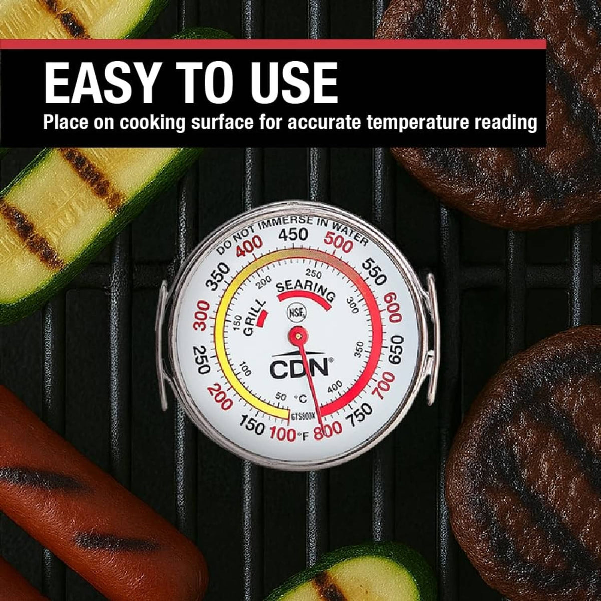 Grill surface thermometer placed on cooking grates with centered dial and red needle
