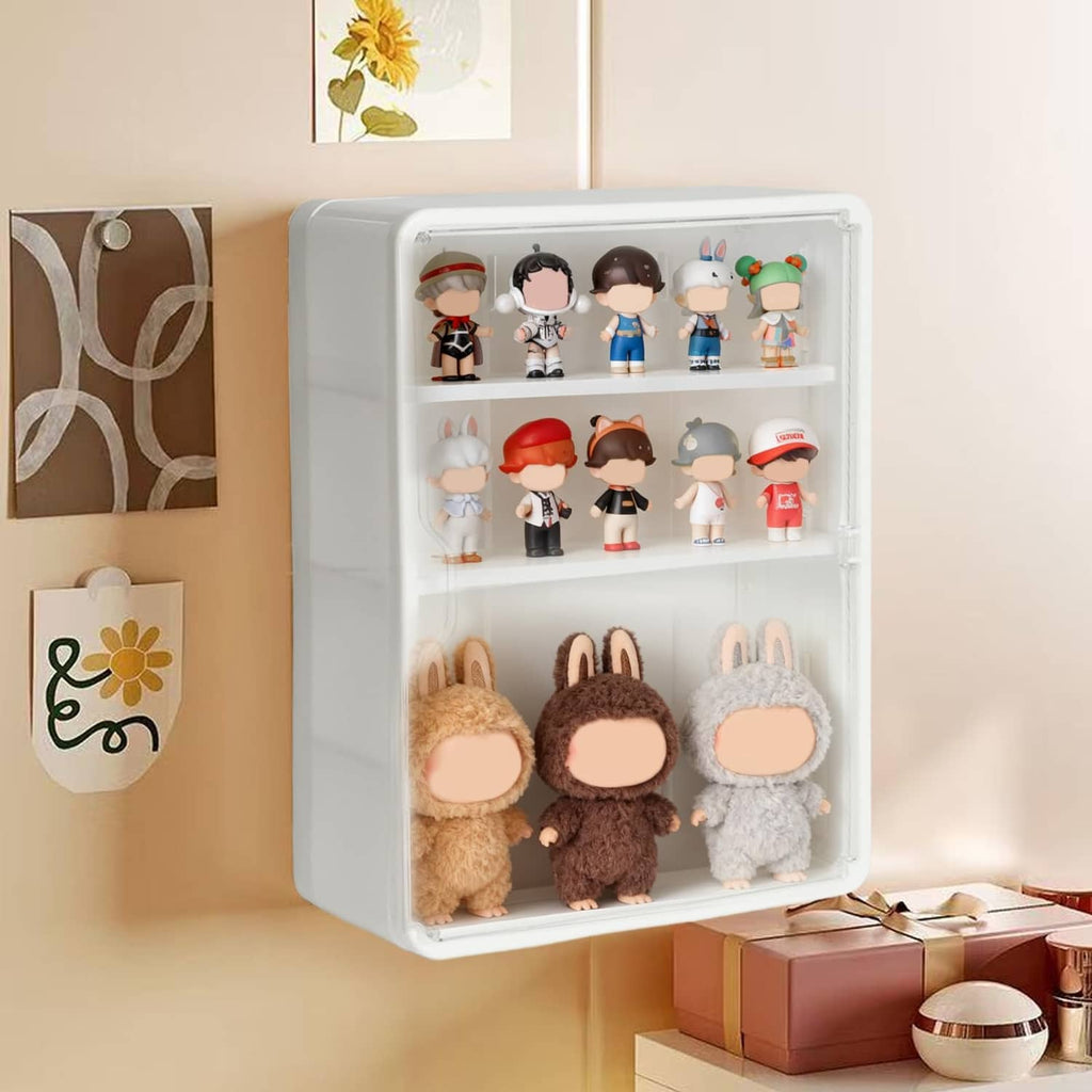 Wall-mounted clear display case with white frame holding figures and plush toys