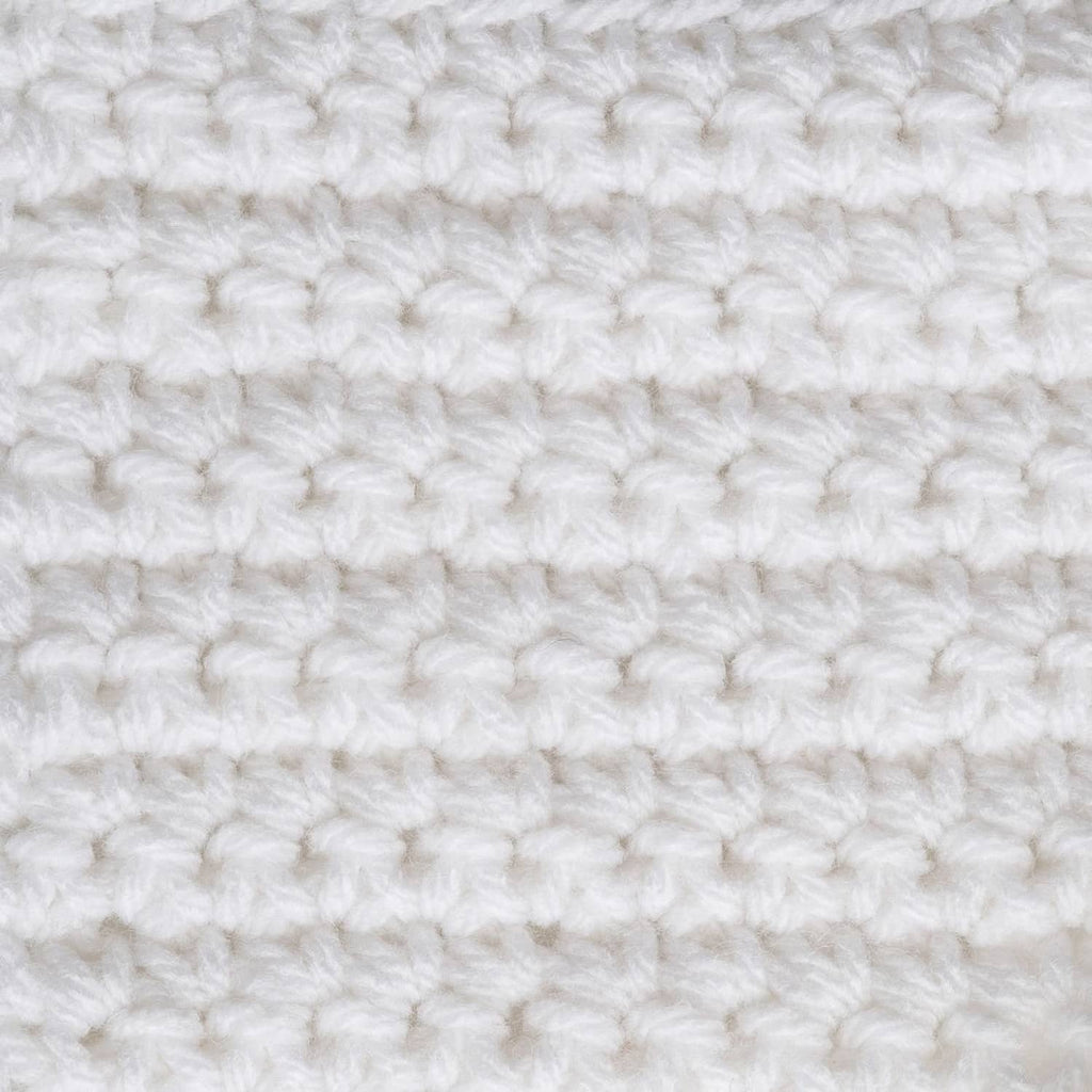 White crocheted fabric with raised loop stitches, close-up