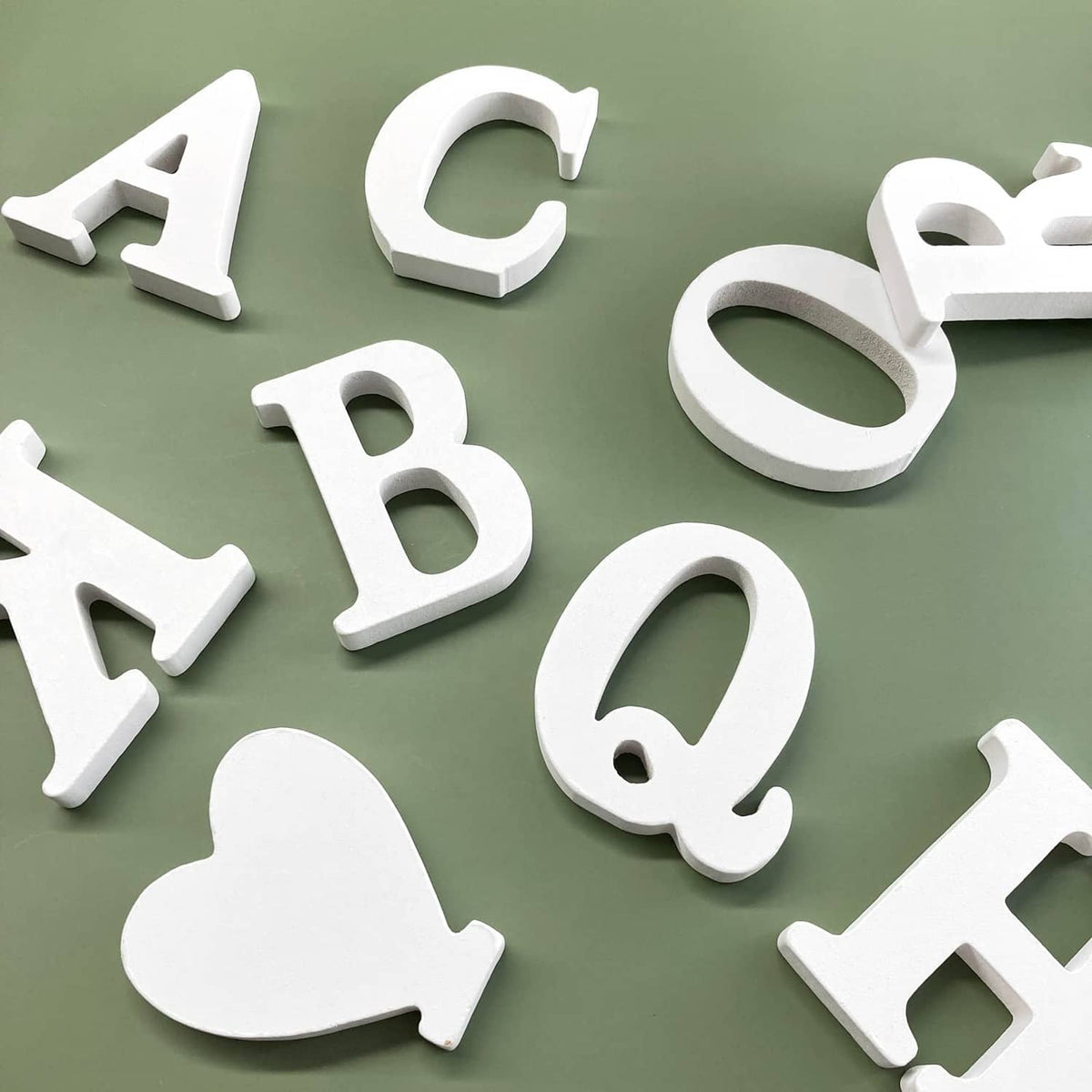 White wood marquee letter cutouts, thick 3D shapes with beveled edges