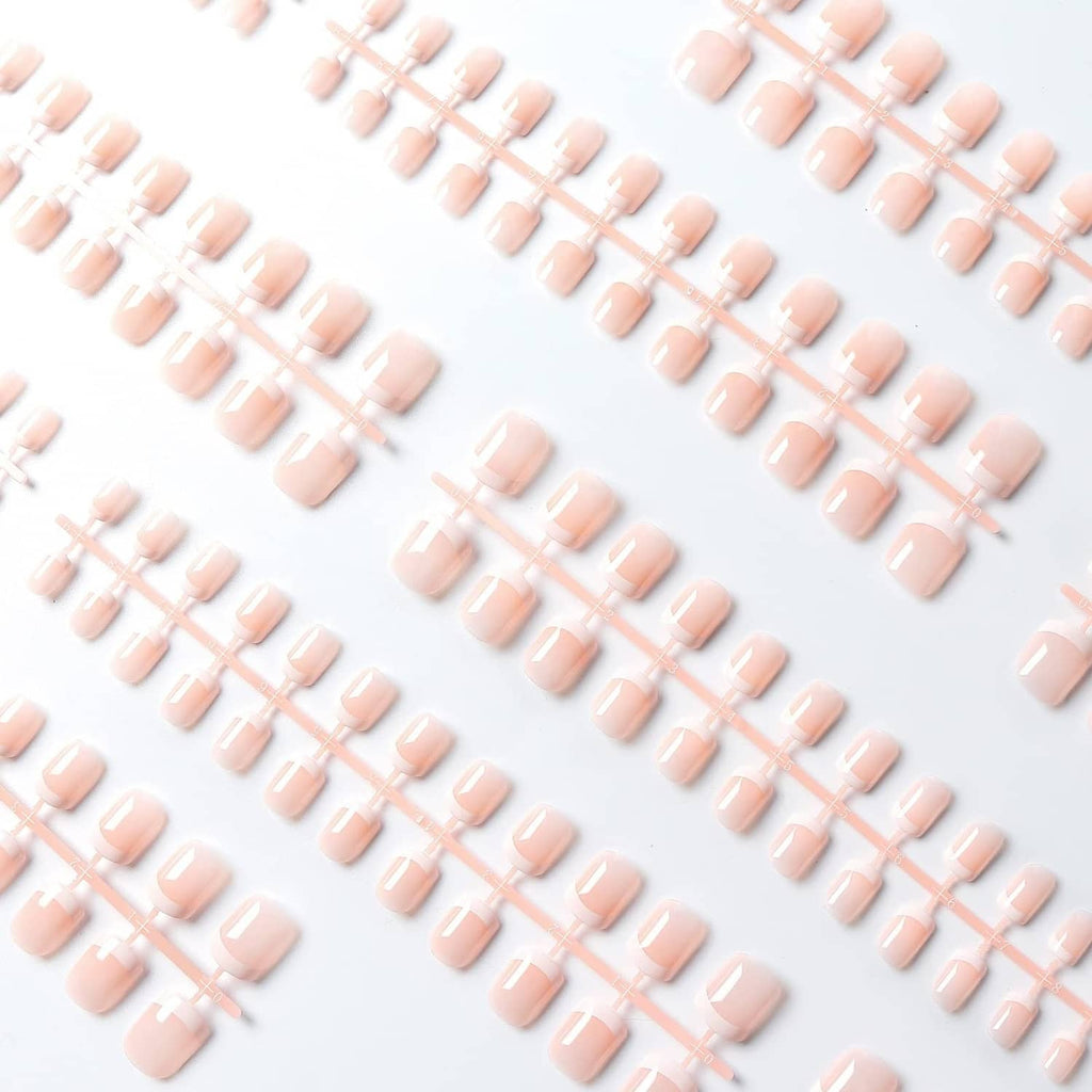 Assorted pink short press-on nails with white French tips, glossy top coat