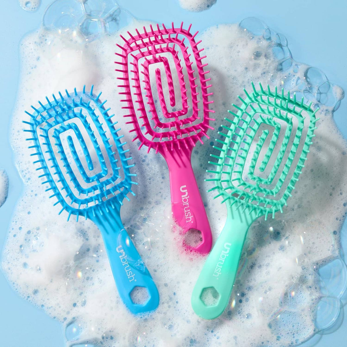 Three-color detangling hairbrush set: pink, teal, and blue with cushion bristles