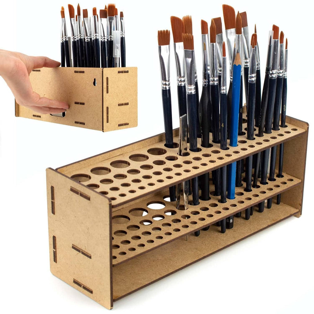 Wooden brush organizer with two rows of holes holding paintbrushes and tools