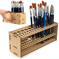 Wooden brush organizer with two rows of holes holding paintbrushes and tools
