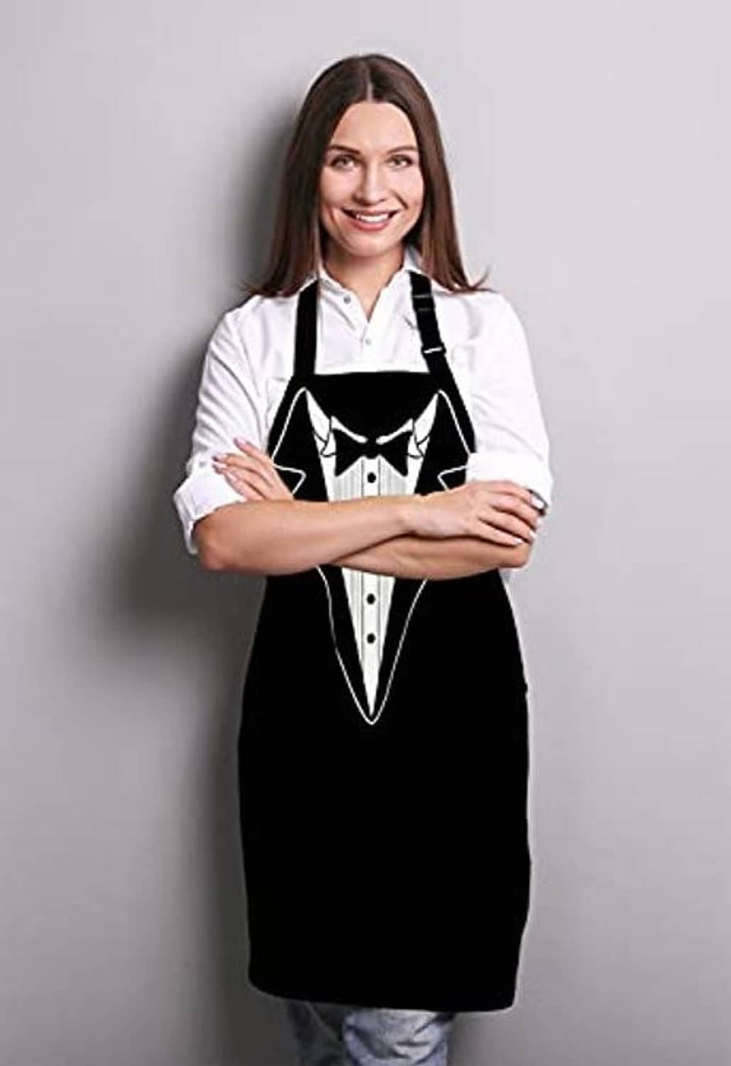 Person wearing a black tuxedo-style BBQ apron over a white button-up shirt.