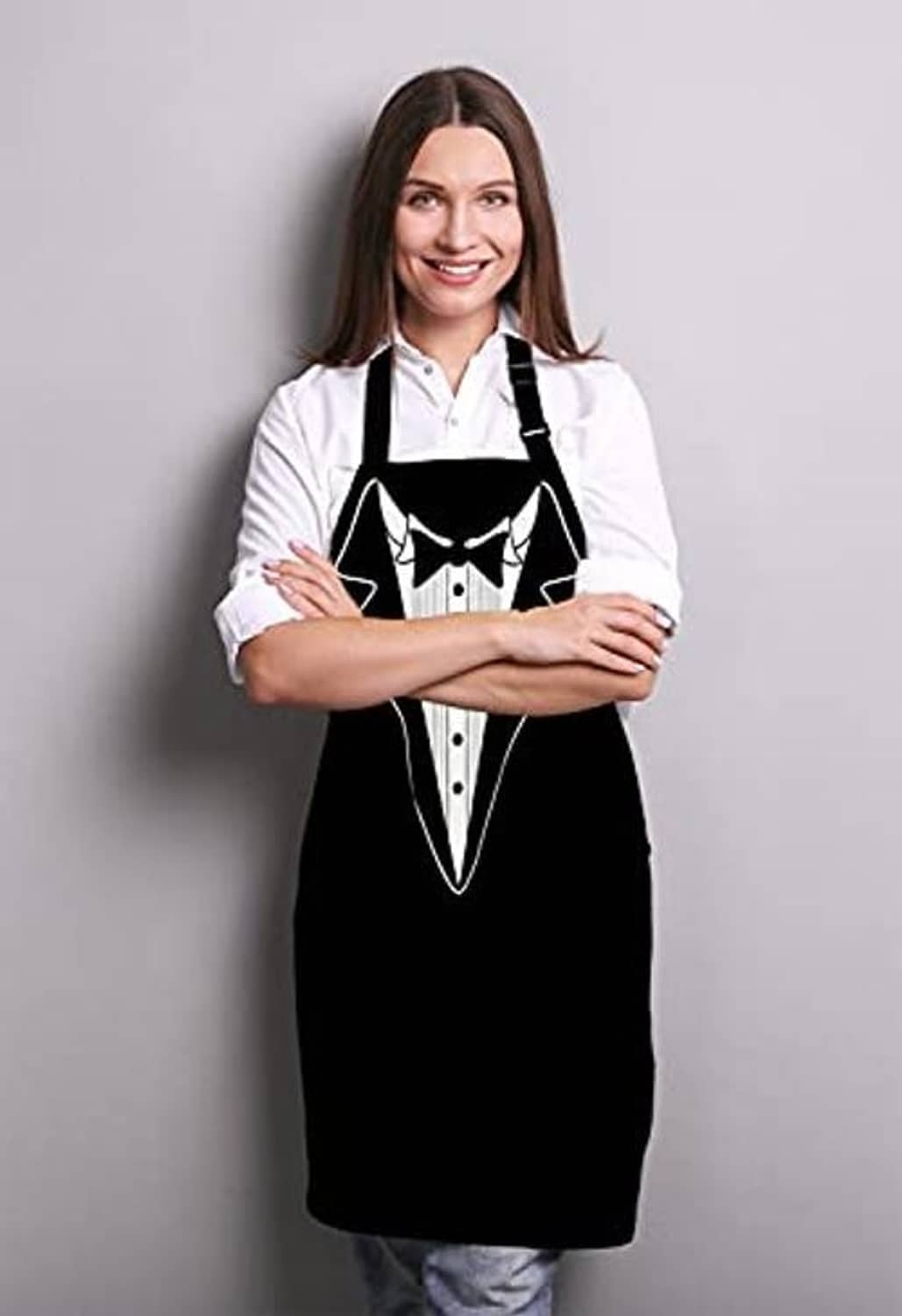 Person wearing a black tuxedo-style BBQ apron over a white button-up shirt.
