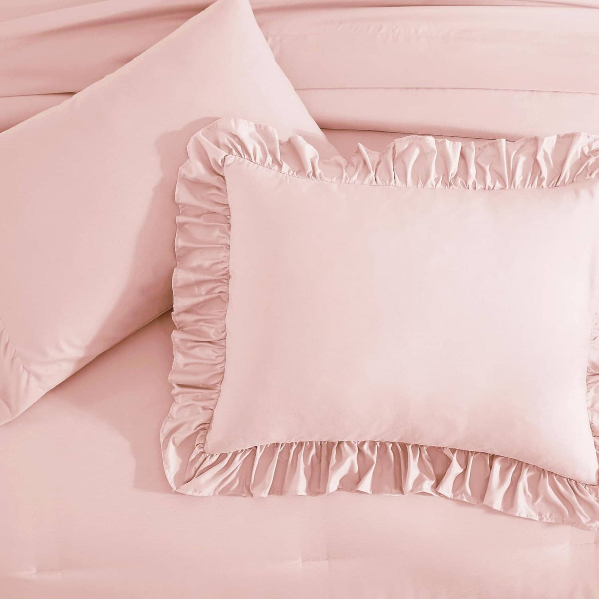 Soft pink pillow sham with ruched double ruffle trim along the edges