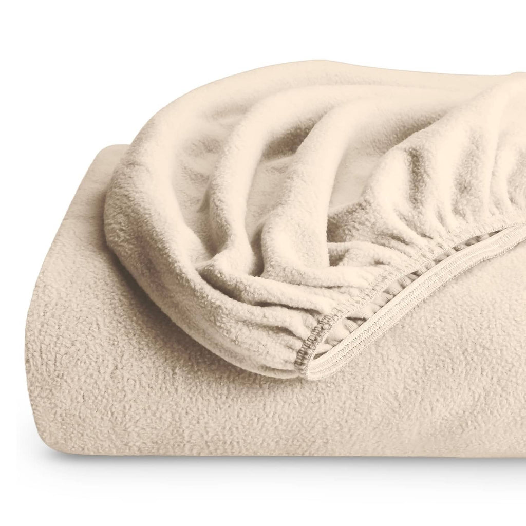 Plush cream fitted fleece bottom sheet with elastic corner seam, soft textured pile.