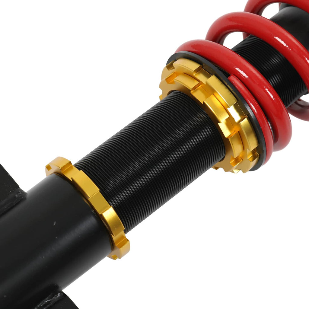Coilover strut with black spring body, gold adjust rings, and red coil