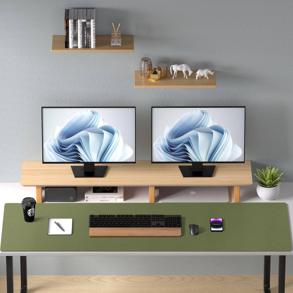 Olive green leather desk pad protector on long desk with keyboard and two monitors