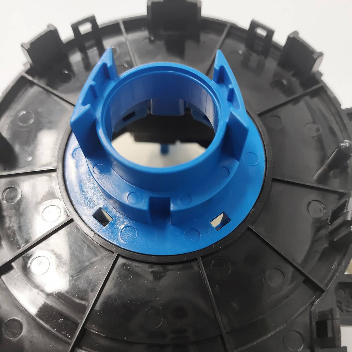 Clock spring slip ring with blue center and black segmented housing