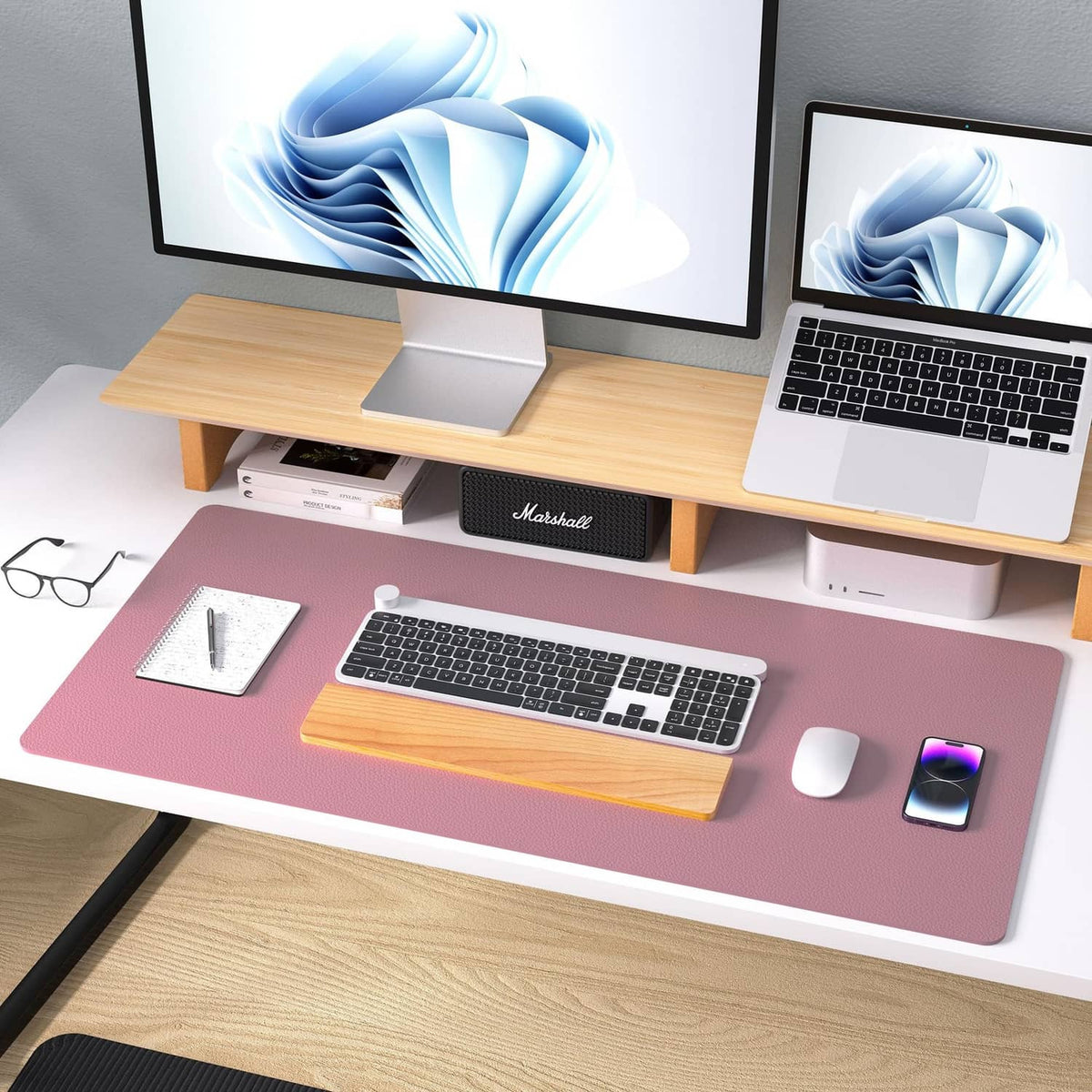 Dark pink leather desk pad with laptop, keyboard, and wireless mouse on desk