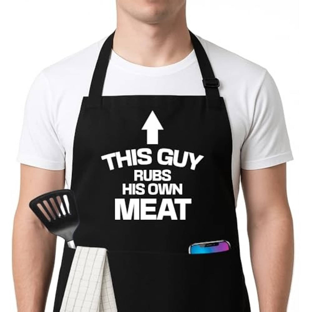 Black apron close-up showing 'THIS GUY RUBS HIS OWN MEAT' text and blue pocket badge