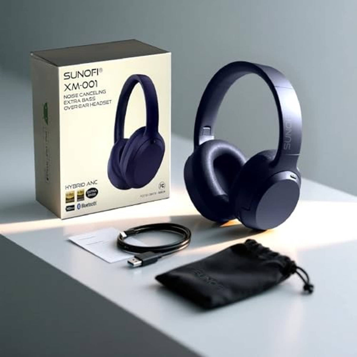 Blue over-ear wireless headphones with retail box, cable, and carrying pouch