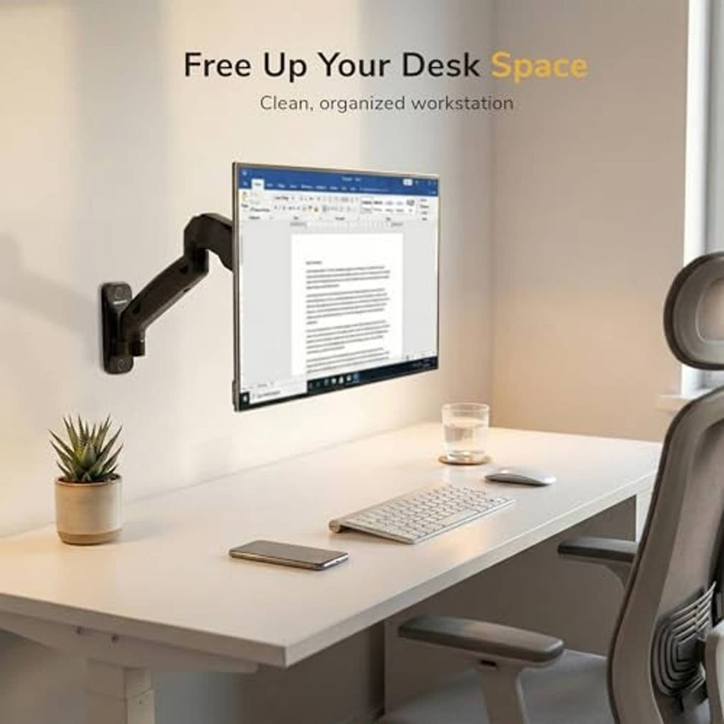 Full-motion monitor wall mount arm above a desk with monitor, keyboard, and mouse