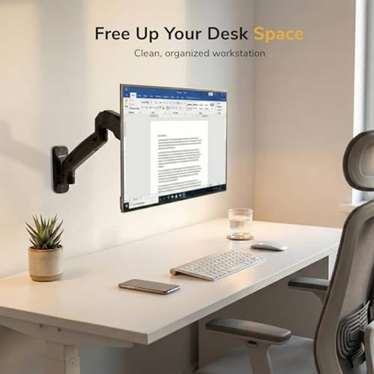 Full-motion monitor wall mount arm above a desk with monitor, keyboard, and mouse