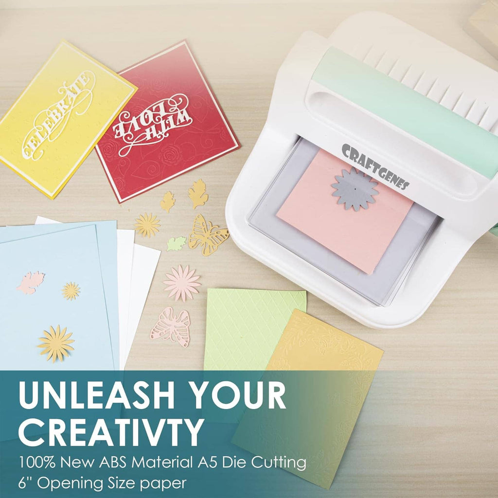 Manual die cutting machine with colorful cardstock and embossed snowflake dies