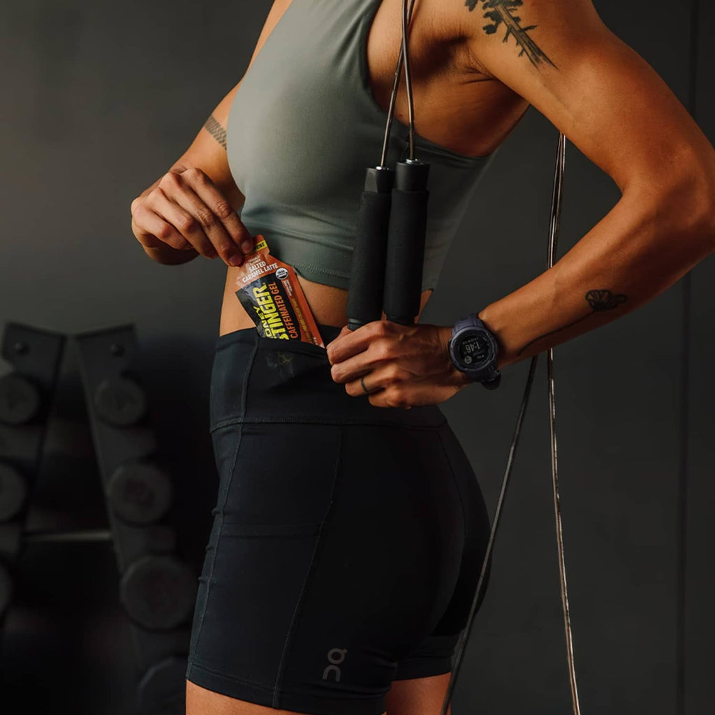 Athlete holding Honey Stinger salted caramel latte caffeinated gel pouch