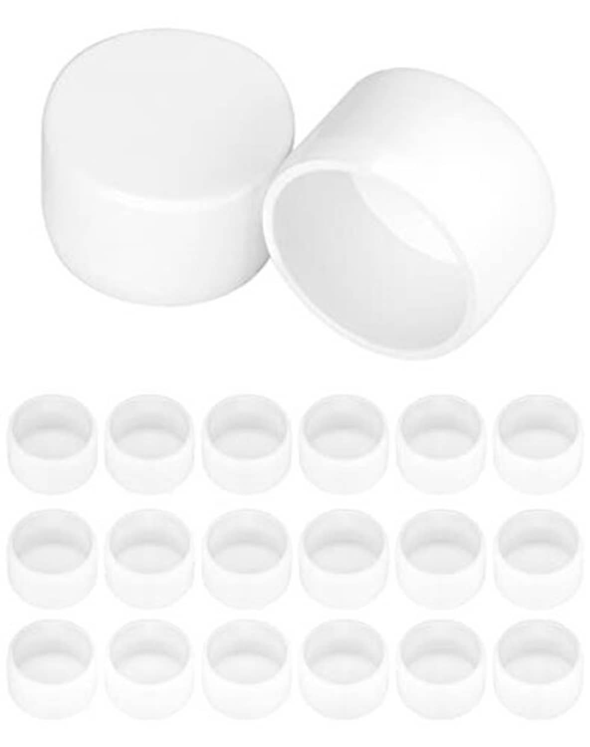 White 1-1/4 in PVC pipe end caps set, two caps shown with smaller caps lineup