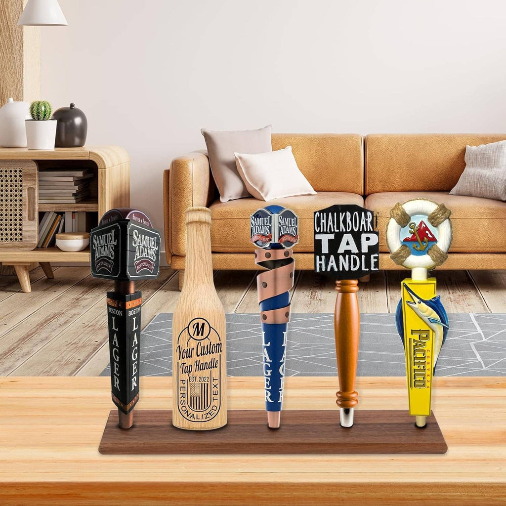 Brown wooden beer tap handle display with four decorative tap handle replicas on base