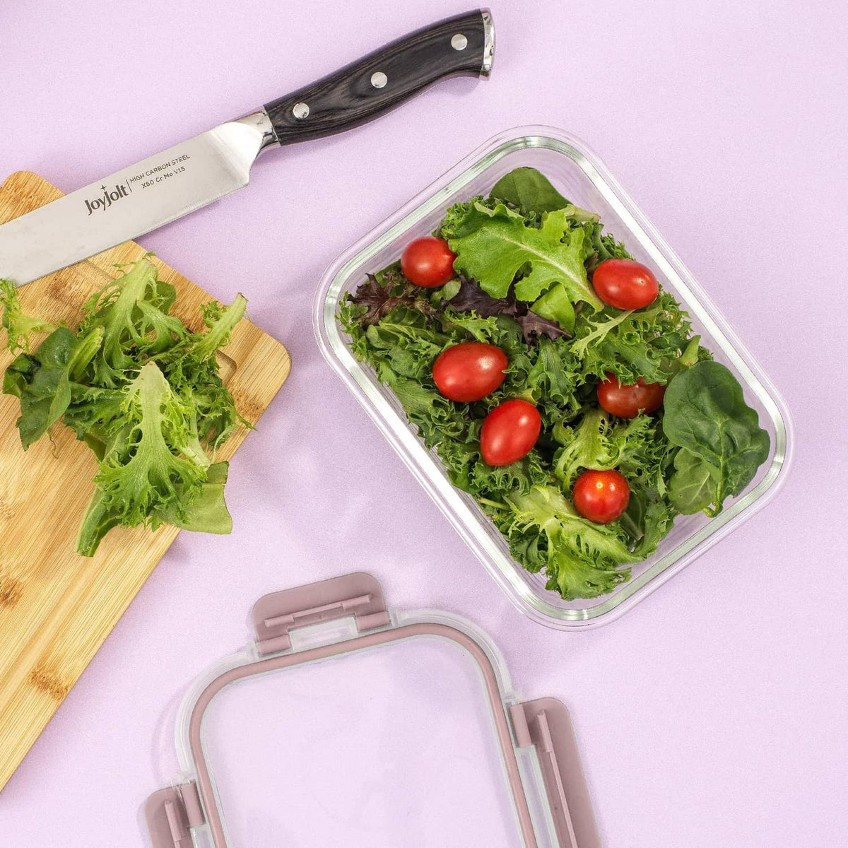 Rectangular borosilicate glass storage container with lid, filled with leafy salad