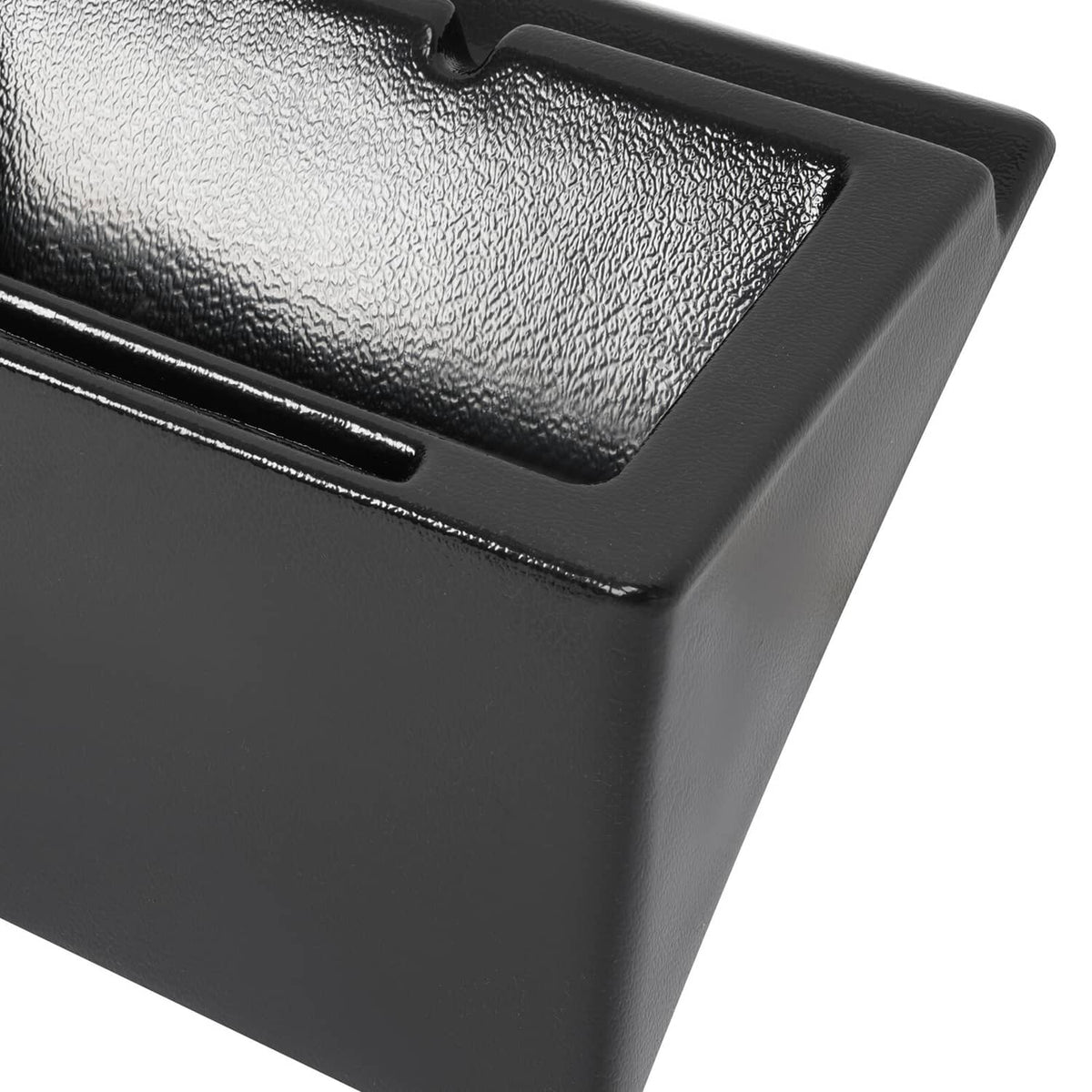 Close-up of black cab caddie top surface and recessed handle opening.