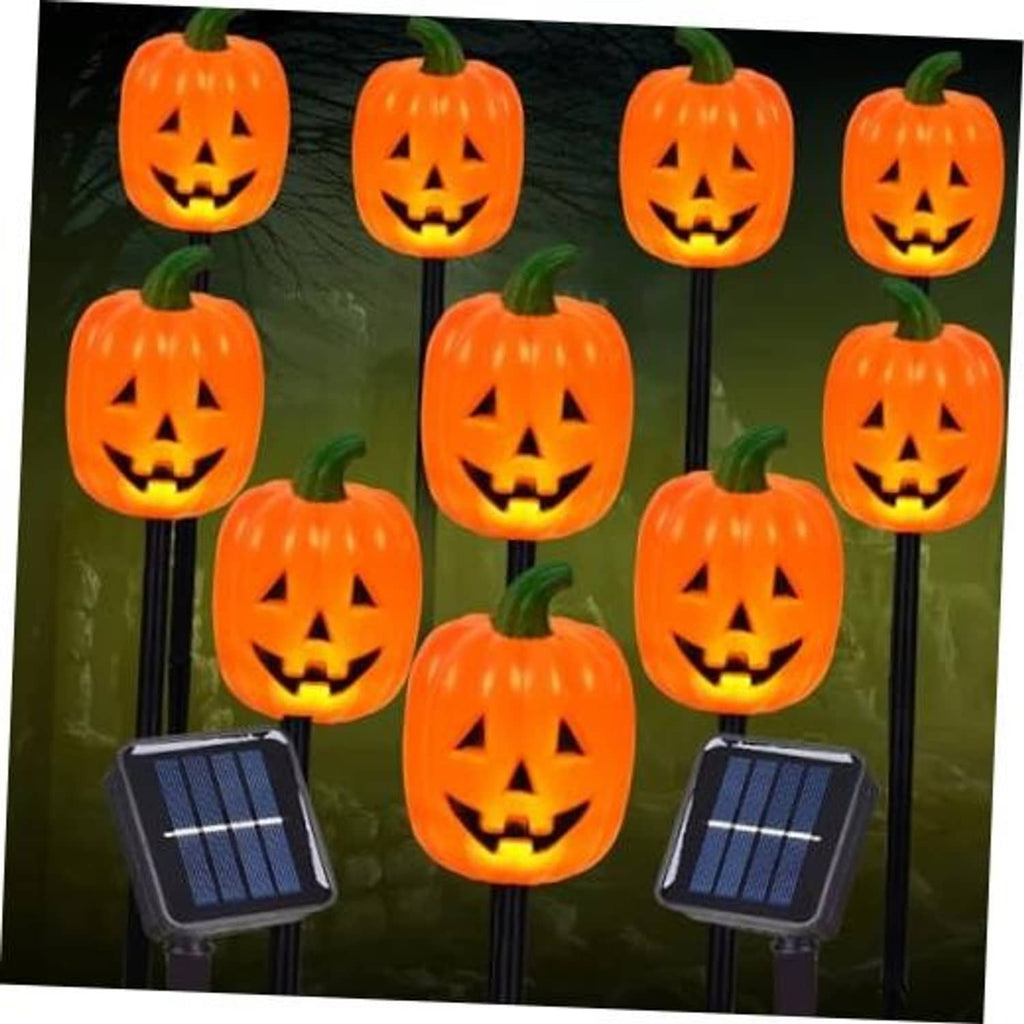 Jack-o'-lantern pumpkin stake lights with solar panels, glowing faces