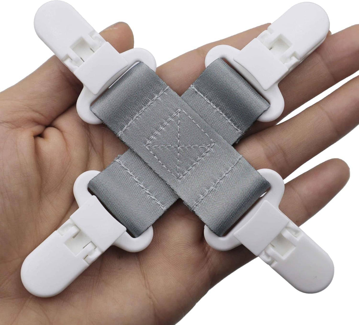 Bed sheet detangler clips with gray fabric straps and white plastic ends