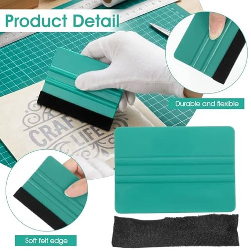 Teal felt squeegee tool with black felt edge, held over vinyl on a cutting mat